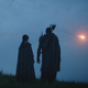 two elves watch an object in the sky